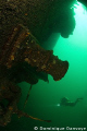   Diver swimming near wreck Keystorm laying 120 feet water StLaurence River. St-Laurence St Laurence River  